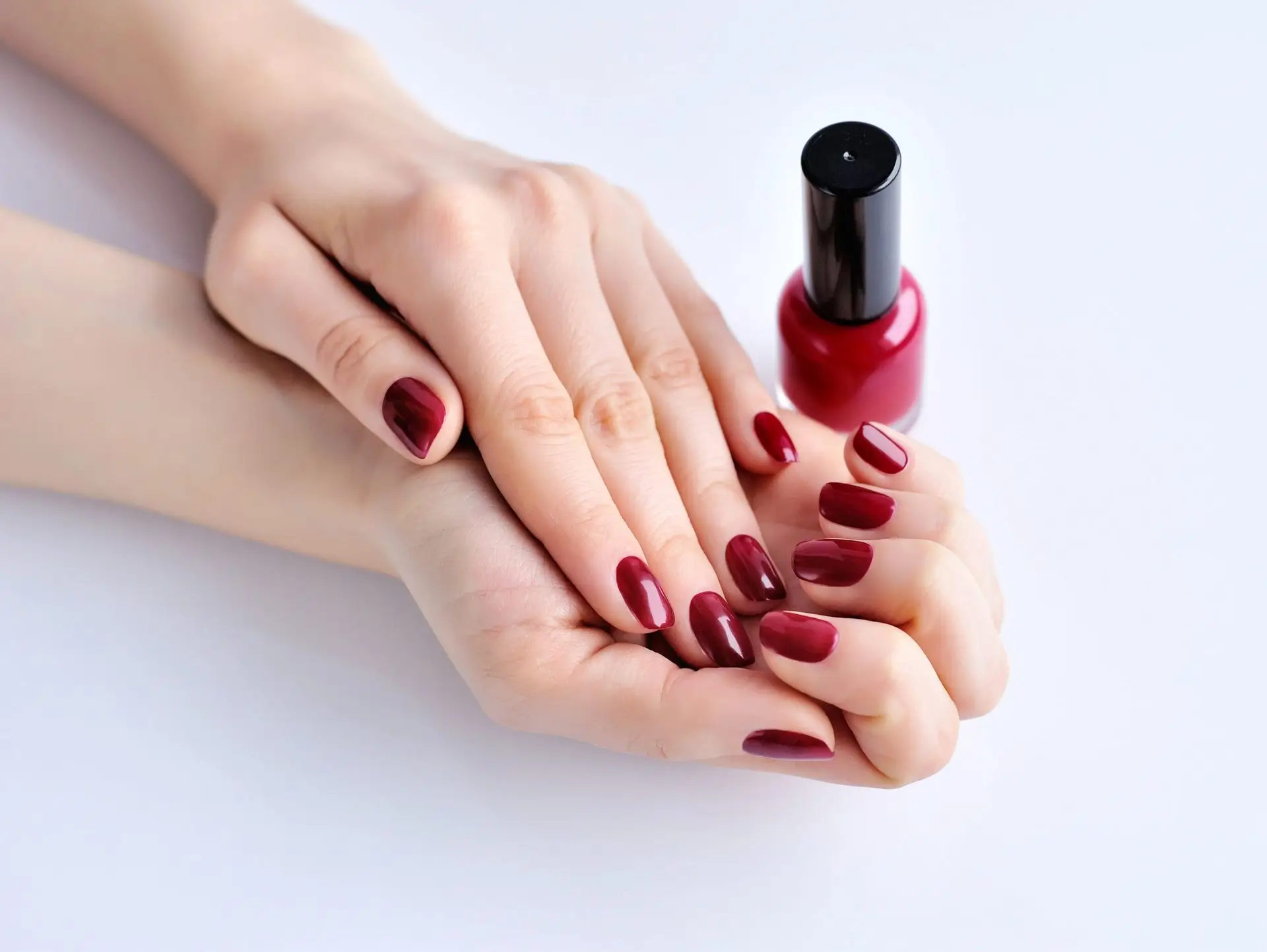 hands-of-a-woman-with-dark-red-manicure-and-nail-P5VNS4S