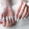 Hands of a young woman with white manicure on nails