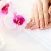 Nails care. Beautiful woman's nails with french manicure, in beauty studio