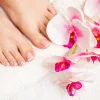 Relaxing french pedicure with a orchid flower