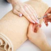SPA manicure. Woman in a nail salon receiving a manicure by a beautician